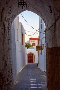 Yunan kenti Lindos 'un Rodos adasındaki beyaz sokaklarının gün batımı manzarası.