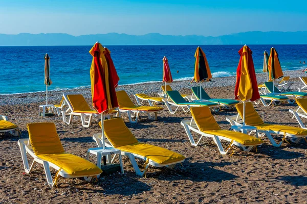 stock image Sunbeds and umbrellas at a beach in Rhodes town in Greece.