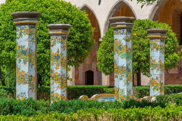 Colorful columns at the cloister of Santa Chiara in Naples, Italy.