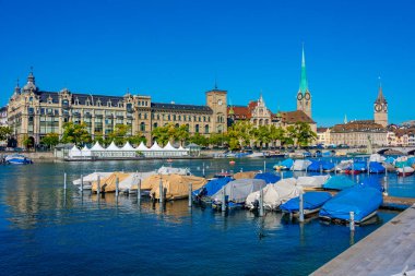 İsviçre 'de güneşli bir günde ünlü Fraumuenster Kilisesi ve Limmat nehri ile tarihi Zuerich şehir merkezinin panoramik manzarası.