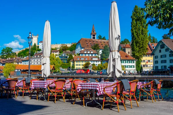 Restaurant with a view of panorama of Spreuerbruecke and historical fortification at Swiss town Luzern.