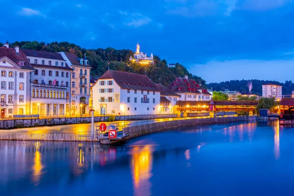 stock image Night view of Spreuerbruecke and Guetsch palace at Swiss town Luzern.