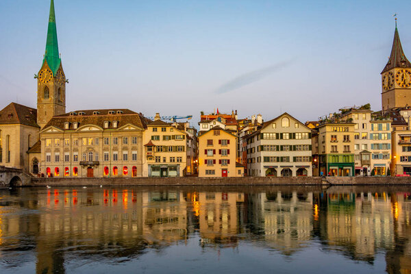 Sunrise view of historic Zuerich city center with famous Fraumuenster Church and river Limmat, Switzerland.