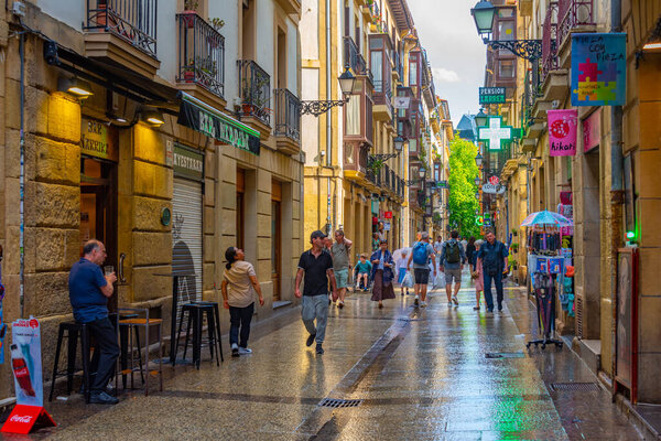 San Sebastian, Spain, June 2, 2022: People are strolling through a narrow street of the old town of San Sebastian, Spain.