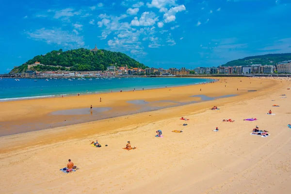 stock image San Sebastian, Spain, June 2, 2022: People are enjoying a sunny day at La Concha beach at San Sebastian, Spain.