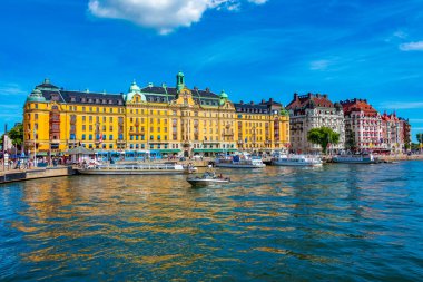 Stockholm, İsveç, 2 Ağustos 2022: Stockholm rıhtımı ve yanında İsveç 'te güzel eski evler.