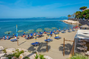 Ischia, Italy, May 23, 2022: People on a beach at Casamicciola Terme marina at Ischia island, Italy. clipart