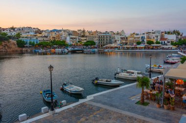 Agios Nikolaos, Yunanistan, 19 Ağustos 2022: Voulismeni gölü ve Yunan kenti Agios Nikolaos 'un Girit adasındaki günbatımı manzarası.