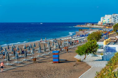 Rodos, Yunanistan, 27 Ağustos 2022: Yunanistan 'ın Rodos kentinde bir plajda güneşlik ve şemsiyeler.