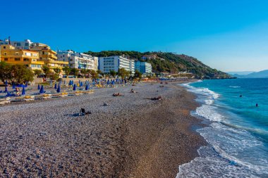 Rodos, Yunanistan, 27 Ağustos 2022: Yunanistan 'ın Rodos kentinde bir plajda güneşlik ve şemsiyeler.