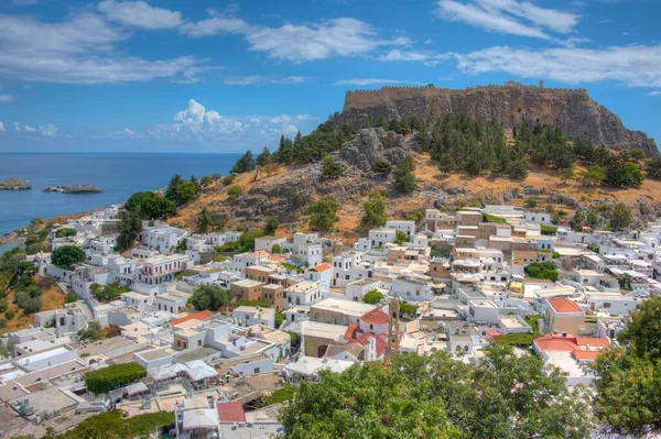 stock image Lindos, Greece, August 25, 2022: Acropolis of Lindos overlooking traditional white houses at Rhodes island, Greece.