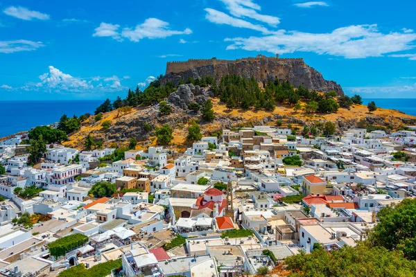 stock image Lindos, Greece, August 25, 2022: Acropolis of Lindos overlooking traditional white houses at Rhodes island, Greece.