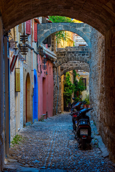 Rhodes, Greece, August 27, 2022: Sunset view of a tourist street in Greek town Rhodes.
