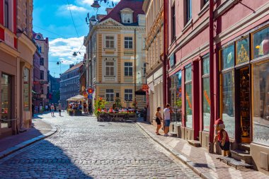 Riga, Letonya, 24 Haziran 2022: Eski şehir Letonya 'da insanlar renkli bir sokakta yürüyorlar..