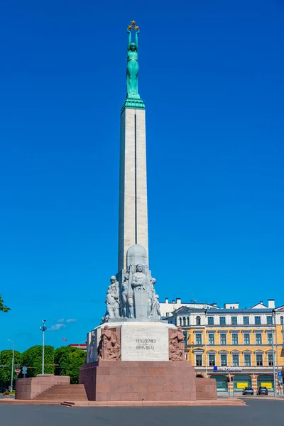 stock image Riga, Latvia, June 24, 2022: People are walking next to the Freedom monument in Riga, Latvia. .