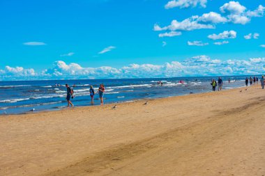 Jurmala, Latvia, July 9, 2022: People are enjoying a sunny day at beach in Jurmala, Latvia. clipart