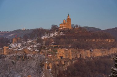 Sunset view of the Tsarevets fortress in Veliko Tarnovo during winter, Bulgaria clipart