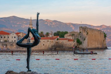 Dancing girl and the old town of Budva, Montenegro clipart