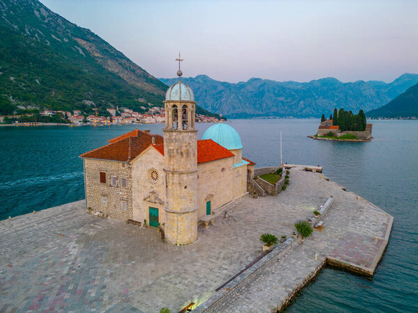 Sunset aerial view of Church of Our Lady of Skrpjela and Saint George Catholic Monastery near Perast in Montenegro