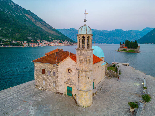 Sunset aerial view of Church of Our Lady of Skrpjela and Saint George Catholic Monastery near Perast in Montenegro