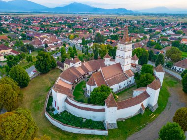 Sunset view of the Fortified Evangelical Church in Harman, Romania clipart