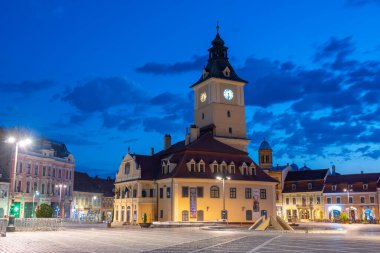 Brasov, Romanya, 15 Ağustos 2023: Romanya 'nın Brasov kentindeki Konsey Meydanı' ndaki belediye binasının gün doğumu manzarası