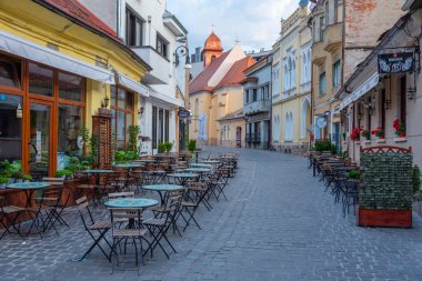 Brasov, Romania, August 15, 2023: Sunrise view of a street in the old town of Brasov, Romania clipart