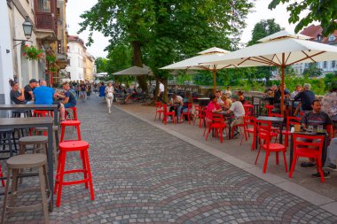 Ljubljana, Slovenya, 18 Haziran 2023: Ljubljana, Slovenya 'daki Ljubljanica nehrinin kıyısındaki restoran terası