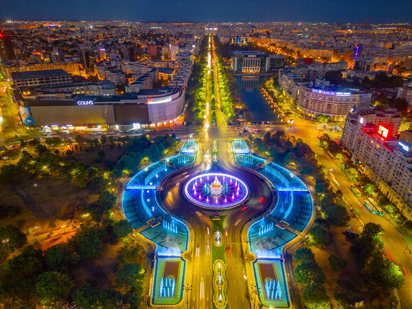 Bucharest, Romania, August 21, 2023: Sunset panorama view of a fountain at the Unirii square in Bucharest, Romania