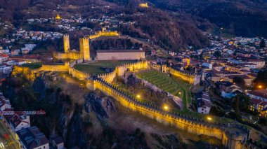 Castelgrande, Castello di Montebello ve Sasso Corbaro şatosuyla gün batımı manzarası.