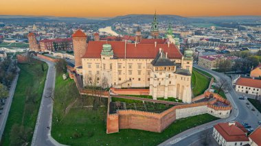 Wawel Kalesi 'nin Polonya şehri Krakow / Krakow' daki günbatımı görüntüsü Vistula / Wisla nehrine yansıdı.