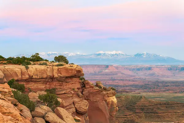View of of snow-capped mountains from Grand View Point Overlook at sunset. Canyonlands National park. Utah. USA