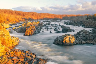 Sunrise over the Great Falls of the Potomac River on a cold winter morning. Great Falls National Park. Virginia. USA clipart