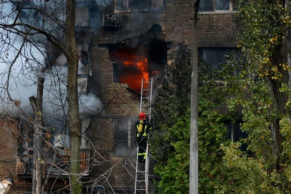 stock image Firefighters work to put out a fire in a residential building hit by a Russian missile strike, amid Russia's attack on Ukraine, in Kyiv, Ukraine November 15, 2022