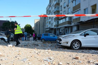 30 Mayıs 2023 'te Rusya-Ukrayna savaşı sırasında Ukrayna' nın başkenti Kyiv 'de meydana gelen gece insansız hava aracı saldırısı sonrasında insanlar hasar gören konut binasının yakınında bekliyorlar..