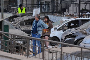 30 Mayıs 2023 'te Rusya-Ukrayna savaşı sırasında Ukrayna' nın başkenti Kyiv 'deki gece insansız hava aracı saldırısı sonrası hasar gören bölgeden ayrılan insanlar görülüyor..