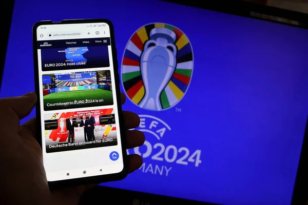 Stock image In this photo illustration, UEFA Euro 2024 (2024 UEFA European Football Championship) logo is seen on a smartphone and a pc screen