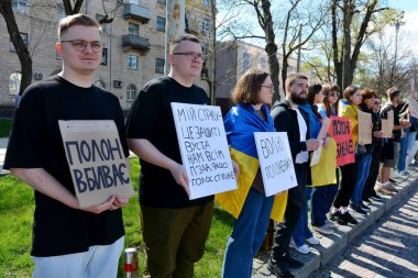 People stand with placards during action 'Don't Be Silent. Captivity Kills' on April 07, 2024 in Kyiv, Ukraine.  clipart