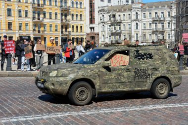The car is camouflaged during action 'Don't Be Silent. Captivity Kills' on April 07, 2024 in Kyiv, Ukraine.  clipart