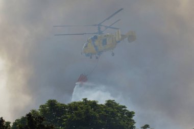 Rusya 'nın Ukrayna' nın Ukrayna 'nın başkenti Kyiv' de düzenlediği saldırı sırasında, bir itfaiye helikopteri Rus insansız hava aracı saldırısının yakınında uçuyor.