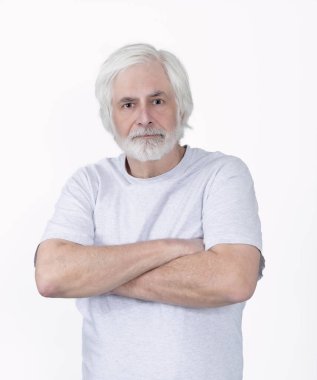 Vertical shot of a scruffy but confident old man with his arms crossed.  Standing from the waist up.  White background.
