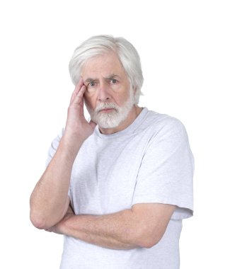 Vertical shot of a troubles or emotionally disturbed old man with his hand to his head.  Standing from the waist up.  White background.