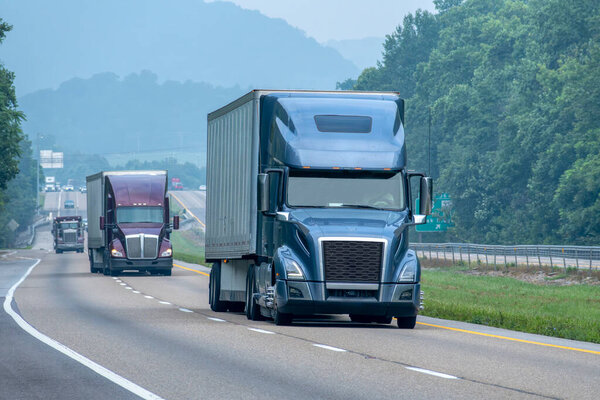 Horizontal shot of interstate truck traffic in Tennessee Smoky Mountain fog.