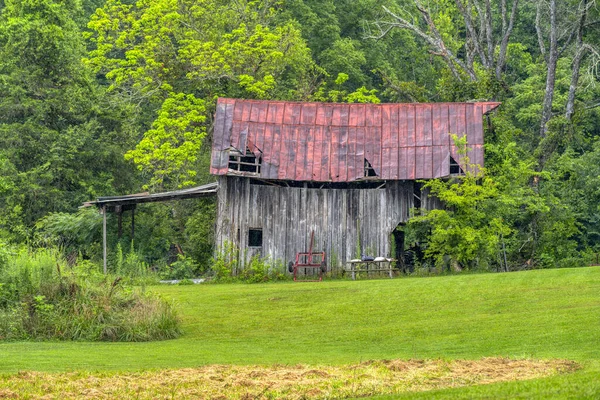 夏の雨の中 捨てられた古い納屋の横のショット — ストック写真