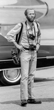 Fort Chaffee, Arkansas, United States - August 10, 1975:  During a 1975 presidential visit by President Gerald R. Ford to Fort Chaffee, Arkansas, presidential photographer David Hume Kennerly awaits the arrival of the President for a speech clipart