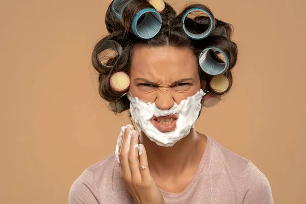 Attractive Angry Woman Hair Curlers Rollers Applyes Shaving Foam Her — Fotografia de Stock