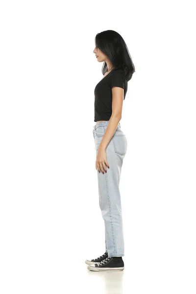 Side View Young Woman Loose Jeans Posing White Studio Background — Stockfoto