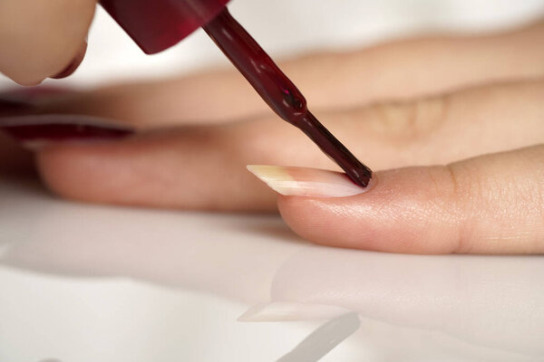 woman applies nail polish. close up