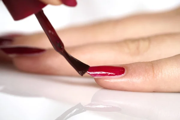 woman applies nail polish. close up
