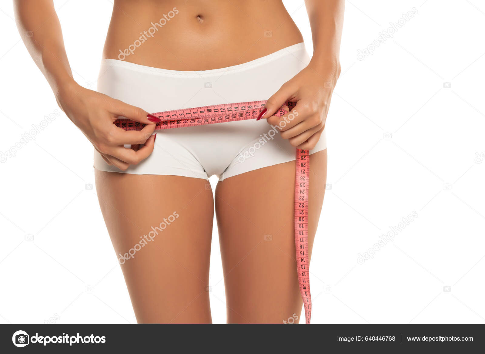 Pretty Caucasian woman measuring her waist measuring tape